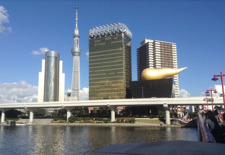 A skyscraper with a massive horn poking horizontally from its side