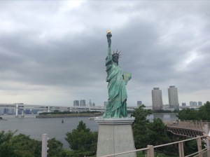 Statue of Liberty in Tokyo, skyscrapers and water behind